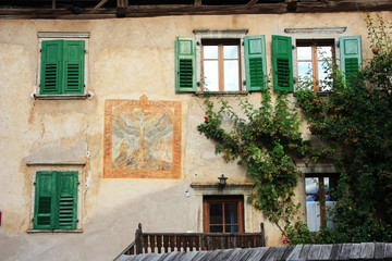 Fototapeta na wymiar Windows of an old Italian house