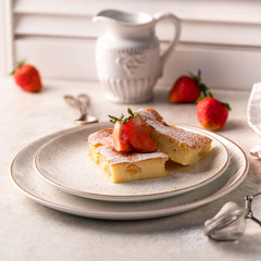 slice of cake, strawberries on background, light bckdrop, white jar