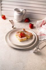 slice of cake, strawberries on background, light bckdrop, white jar
