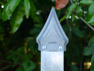 Metal fence of the city park with sharp tips