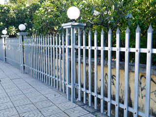 Metal fence of the city park with sharp tips