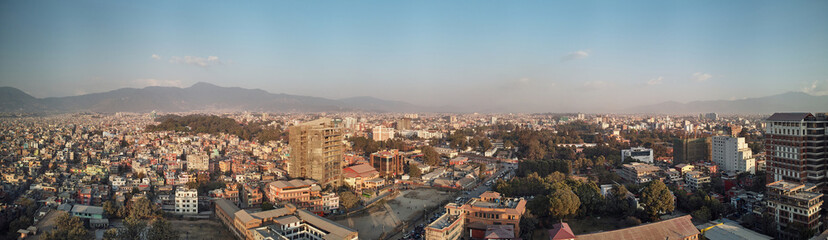 Fototapeta na wymiar Panoramic view from the drone to the capital of Nepal, Kathmandu. Sunset cityscape in Thamel district, the main tourist and historical district of Kathmandu