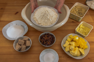 On a wooden table are all the ingredients for a Christmas stollen. These are given in a bowl. Concept: Christmas and baking