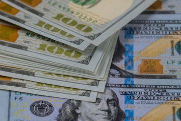 One hundred american dollar bills, close up.
