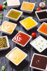 Set of different sauces in ceramic bowl