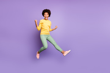 Fototapeta na wymiar Full size photo of crazy brunette hair girl hear incredible fall spring lottery victory feel impressed jump raise fists scream yeah wear casual style outfit isolated violet color background