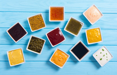 Set of different sauces in ceramic bowl