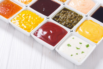 Set of different sauces in ceramic bowl