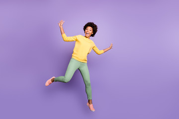 Fototapeta na wymiar Full length photo of amazed excited teenager girl have fun autumn fall holidays greet friends feel crazy like child jump scream wear casual style outfit isolated violet purple color background