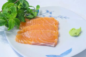 sashimi salmon on plate with Mint leaves and wasabi