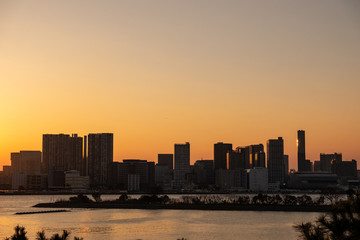 landscape golden sunset light with shadow of city tower  and  front of river 