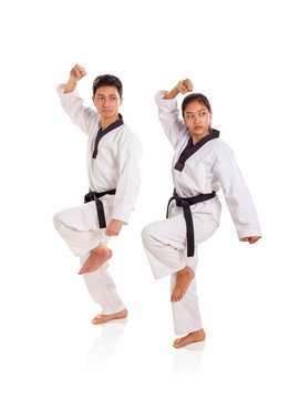 Two professional athlete showing a tae-kwon-do move