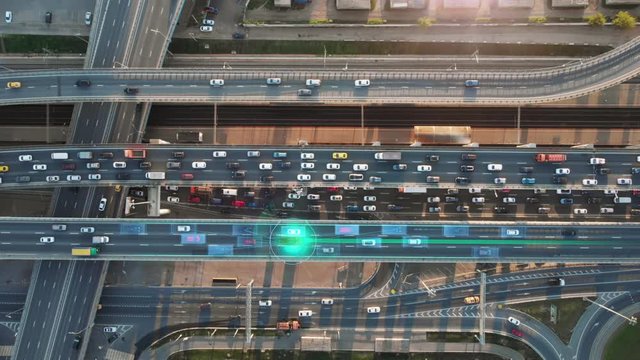 Beautiful top view to autonomous cars self-driving on multi-level highway in Moscow. Picturesque aerial panorama of the road traffic in a big city on the evening.
