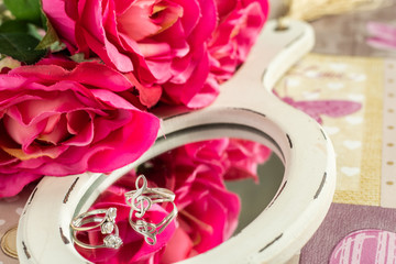 Roses and rings reflected in a mirror