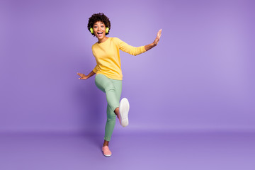Fototapeta na wymiar Full length body size view of nice attractive cheerful cheery crazy clumsy wavy-haired girl listening music having fun strolling fooling dancing isolated on violet purple lilac pastel color background