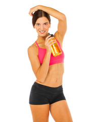 Young athletic girl drinks water from a bottle - isolated on white background