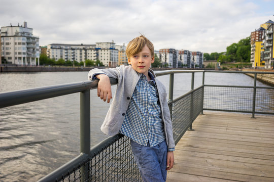 Boy posing next to a river