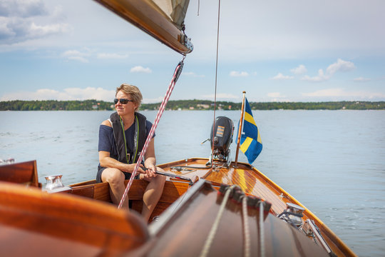 Mid adult woman sailing on her yacht