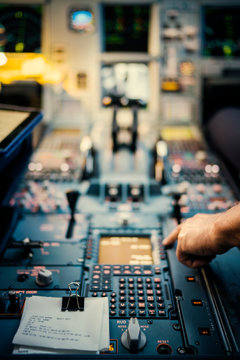 Pilot?s hand on airplane control panel