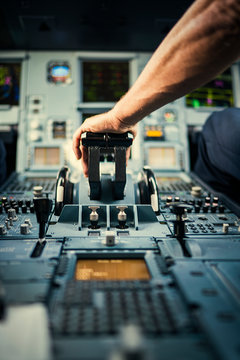 Pilot?s hand on airplane control panel