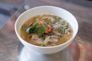 Traditional Vietnamese beef soup pho in a local Vietnamese restaurant.