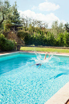 Woman diving into swimming pool