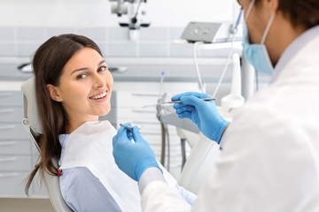Happy woman making check up in dental clinic