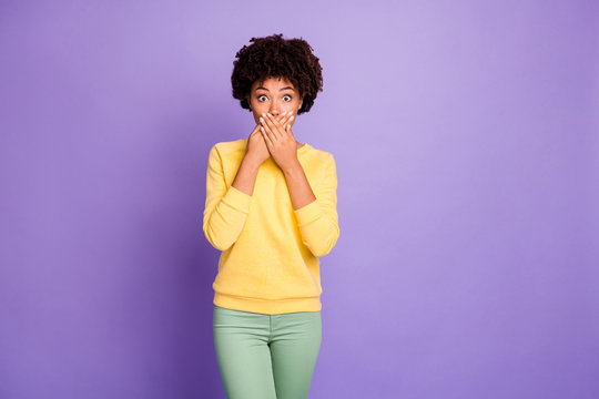 Photo of frightened horrified terrified girlfriend covering her mouth with hands after having told restricted private informaion wearing green pants trousers yellow sweater trendy stylish isolated