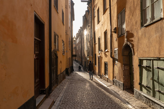 Teenage boy walking on alley in old town of Stockholm, Sweden