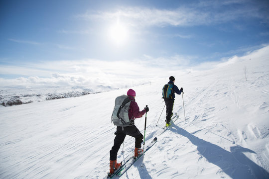 Two people cross country skiing
