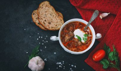 Borscht, russian soup, healthy dinner, top view, black table.