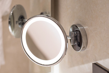 Bathroom cosmetic beauty mirror with halo rim lighting.