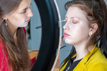 Make-up artist puts shadows on the face close-up