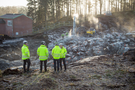 Men talking in front of a construction site