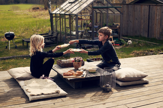 Children sharing meal on deck