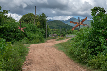 Rural scenery around the town of Trinidad de Cuba in October 2019 with a sign saying 