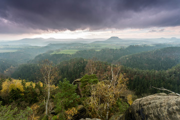 View of the Lilienstein Plateau. Autuum mood with dark clouds, Elbstandstein mountains landscape....