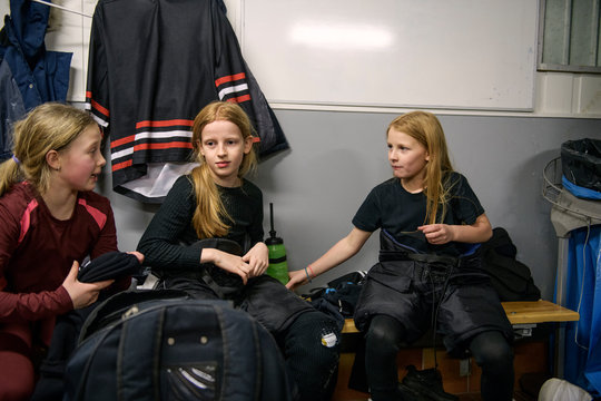 Girls in changing room prepare for ice hockey training