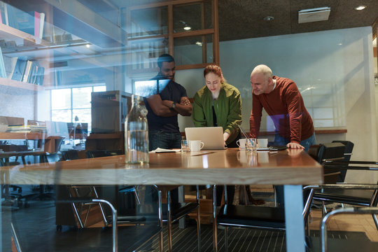 View through window of businesspeople in meeting