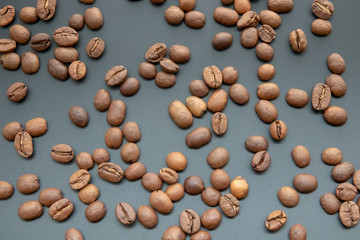 Roasted coffee beans on black background close up