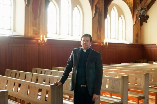 Portrait Of Priest In Church