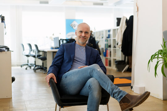 Portrait of businessman sitting in armchair