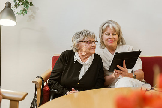 Senior woman learning to use tablet PC