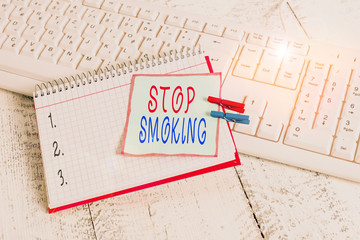 Conceptual hand writing showing Stop Smoking. Concept meaning the process of discontinuing or quitting tobacco smoking notebook reminder clothespin with pinned sheet light wooden