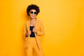 Portrait of attractive dreamy afro american girl look have rest relax enjoy vogue time feel confident wear stylish fashionable clothes isolated over yellow bright color background