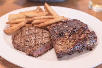 Rib eye Steak and Ribs with Potato Fries.