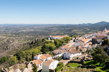 Fototapeta na wymiar View of Marvao village with beautiful houses and church with rocky landscape mountains behind