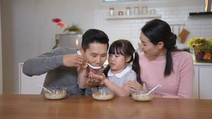 Fototapeta premium Family concept. The family is having breakfast together. 4k Resolution.