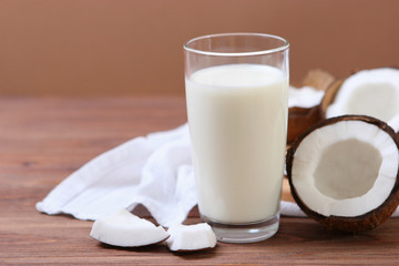 Milk and broken coconuts on the table. Vegetable milk, a veggie drink.