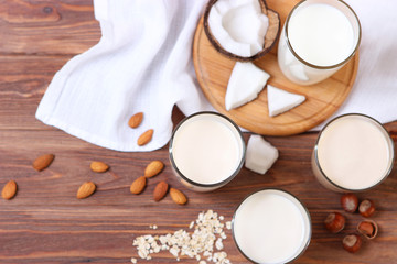 Different types of vegetable milk on the table. Coconut, oatmeal, hazelnut, almond milk. Vegetarian milk.